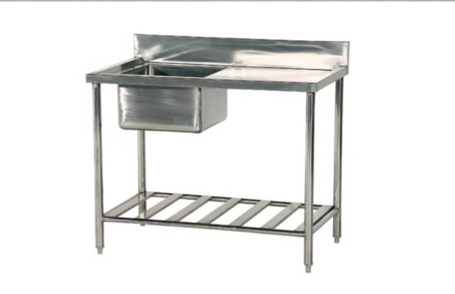 Undercounter dishwasher installed beside a stainless steel sink table