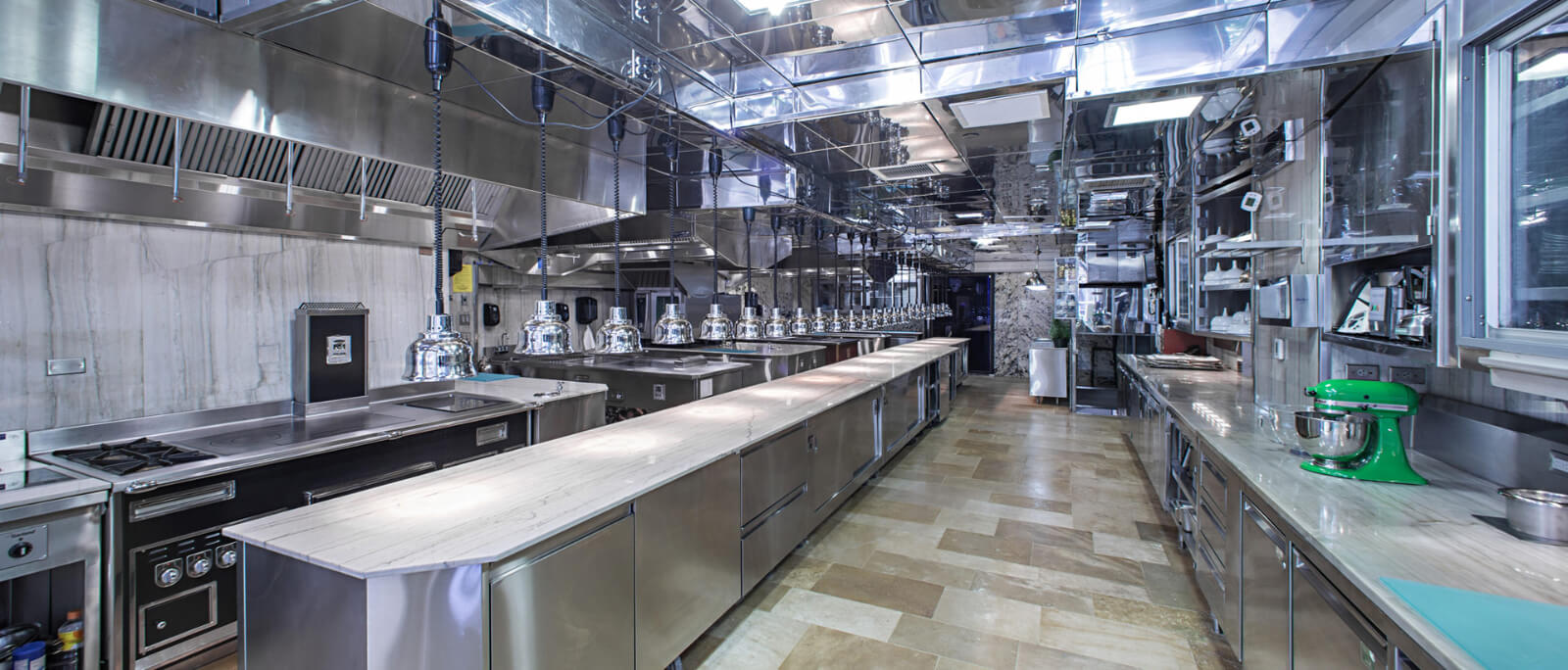 Commercial kitchen interior with stainless steel preparation counters
